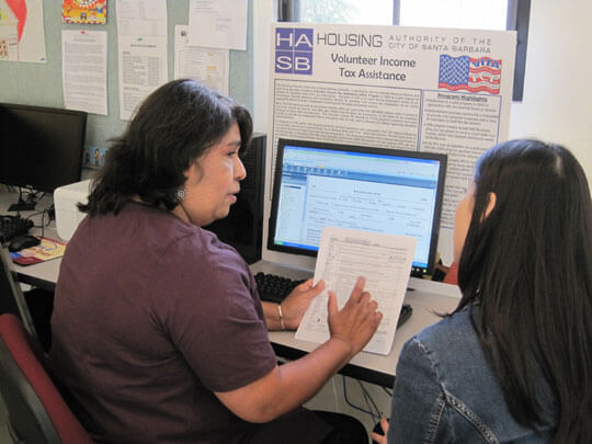 Mariluz Meza, a longtime VITA volunteer  and assistant site coordinator, helps with income-tax preparation at one  of the Housing Authority of the City of Santa Barbara centers