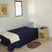 El Carrillo apartment bedroom with blue sheeted bed