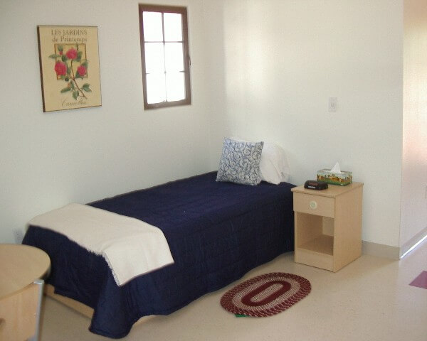 El Carrillo apartment bedroom with blue sheeted bed