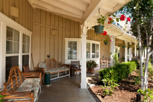 Outside shot of benches and chairs on the porch of the property