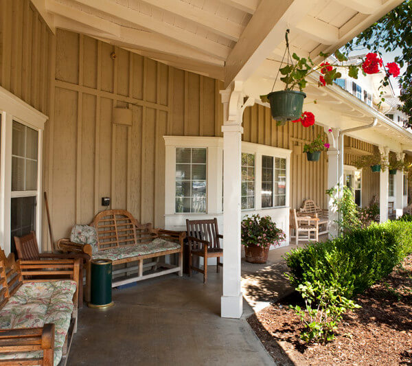 Outside shot of benches and chairs on the porch of the property