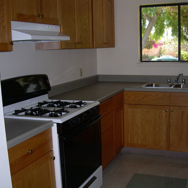 Inside a unit, showing the stove and kitchen sink