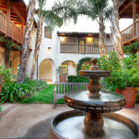 Outside shot of the courtyard with a water fountain and the units in the background