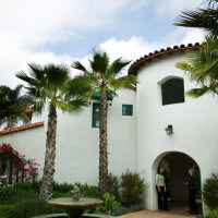 Outside view of two women standing at the entryway near the water fountain