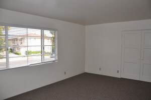 Inside a unit, view of the living room and window showing the street