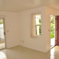 Inside a unit, view of the living room with the open door and sliding glass door