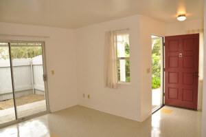 Inside a unit, view of the living room with the open door and sliding glass door