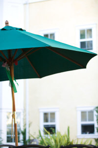 Outside shot of an in-focus umbrella with the units in the background