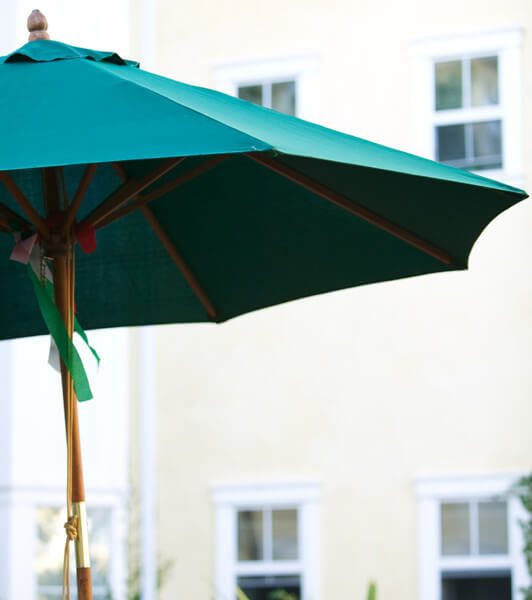 Outside shot of an in-focus umbrella with the units in the background