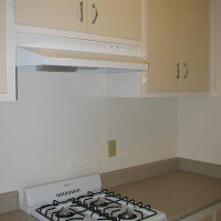 Inside a unit, view of the stove and cabinets