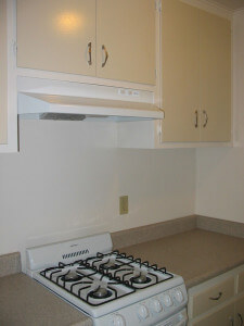 Inside a unit, view of the stove and cabinets