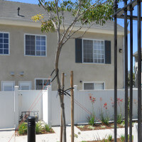 Outside view of a white fence and a unit behind it