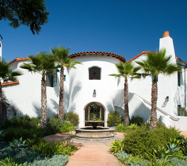 Outside shot of the property and a small fountain in front of it