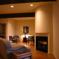 Inside view of the common room, focus on a few couches and the fireplace