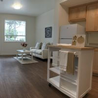 View of kitchen and living room at Grace Village Apartments