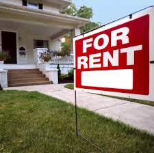 House with FOR RENT sign in front