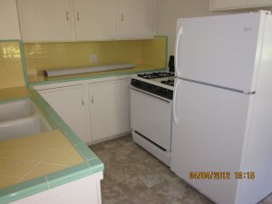 Kitchen with stove and refrigerator